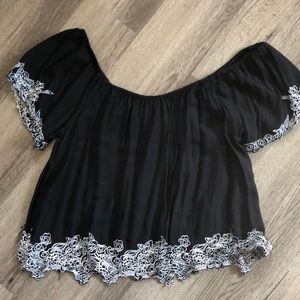 Off the shoulder black top with white outline